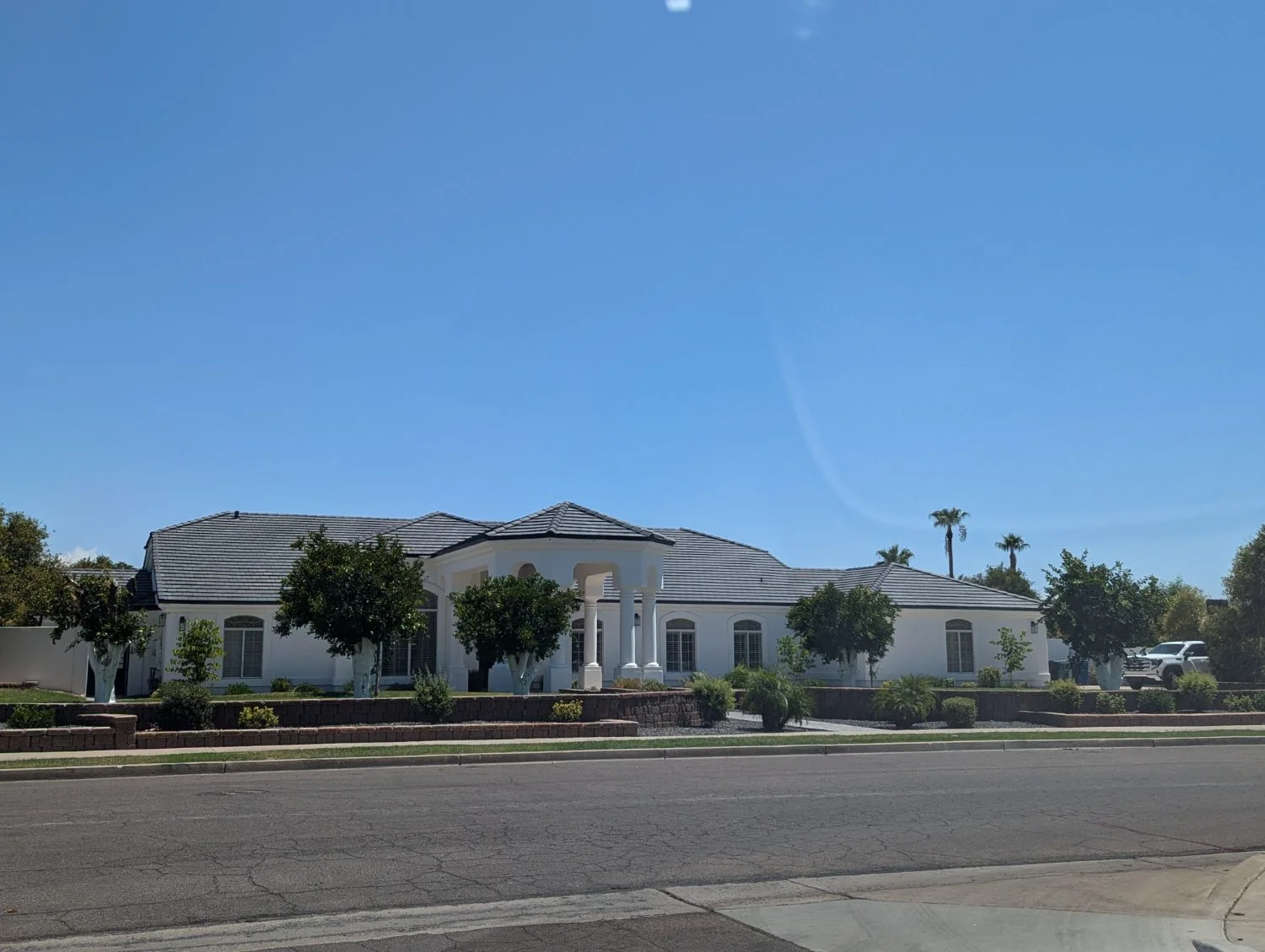 Street view of a completed tile roof on an estate home
