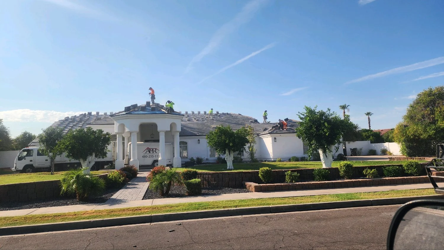 New tile roof on a white estate home