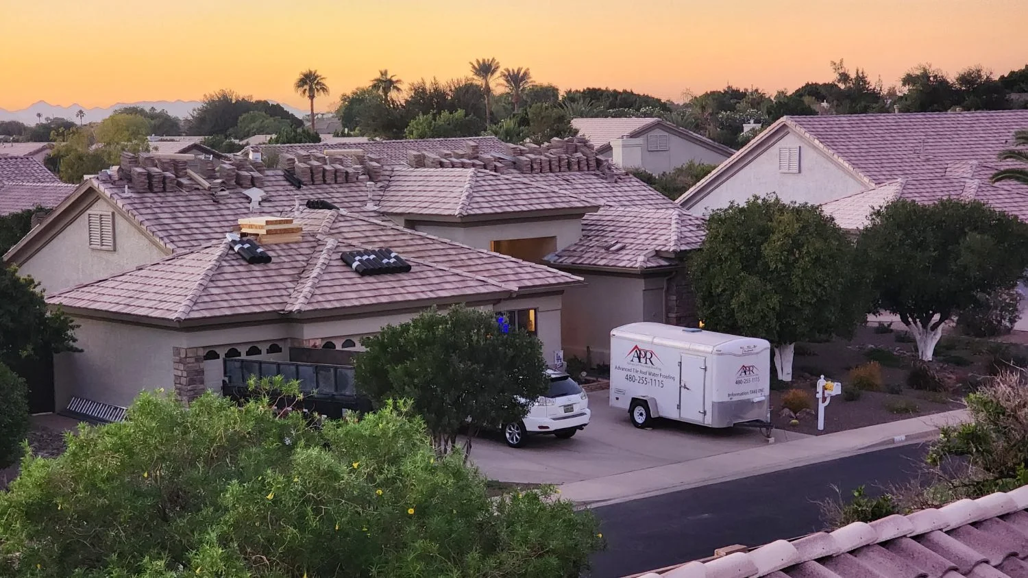 Hero photo: wide shot of a completed tile roof at golden hour