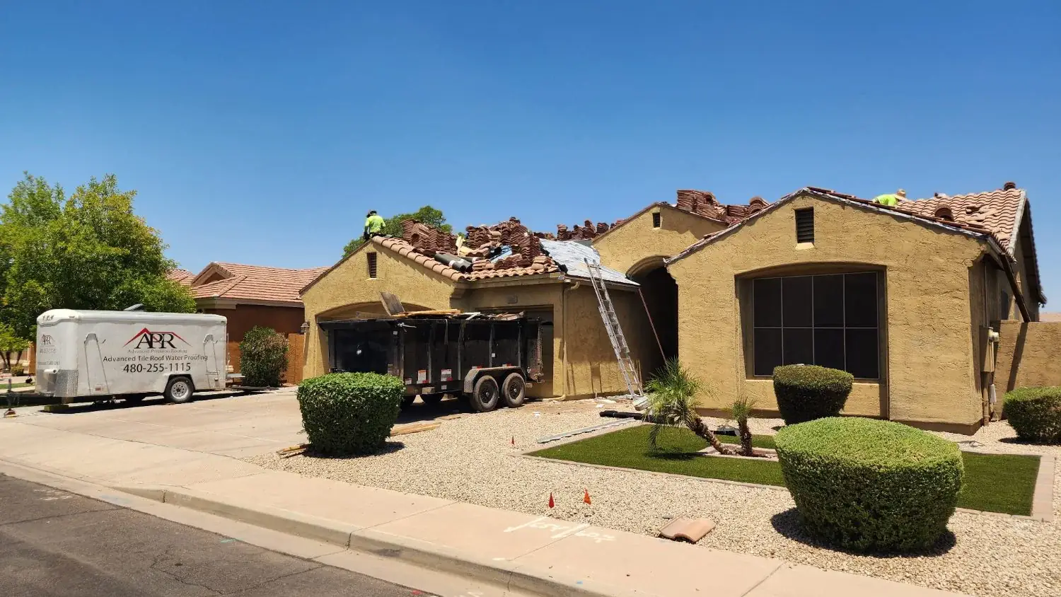 Tile roof tear-off in progress with tile stacked aside